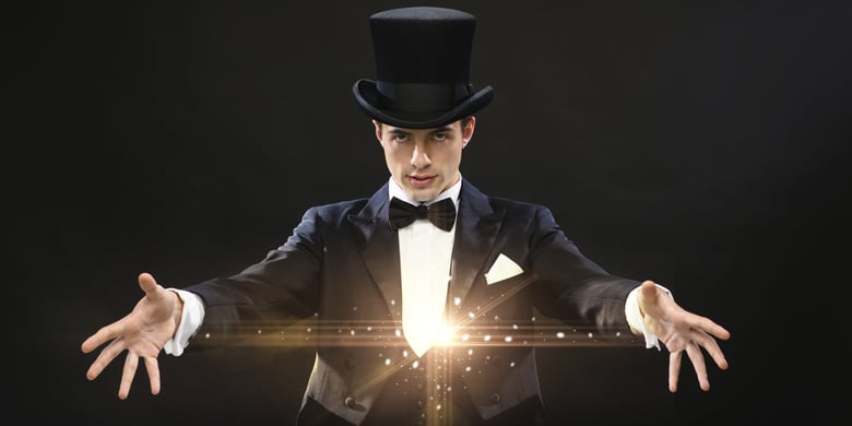 magician in top hat showing trick