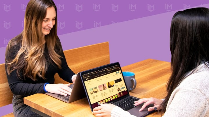 Content marketer interviewing a subject matter expert while working on laptops 